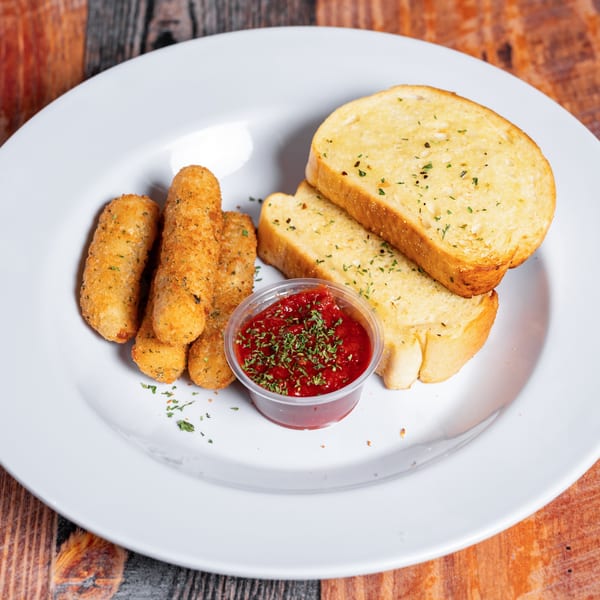 Golden mozzarella sticks, garlic bread, and a cup of marinara sauce on a white plate.