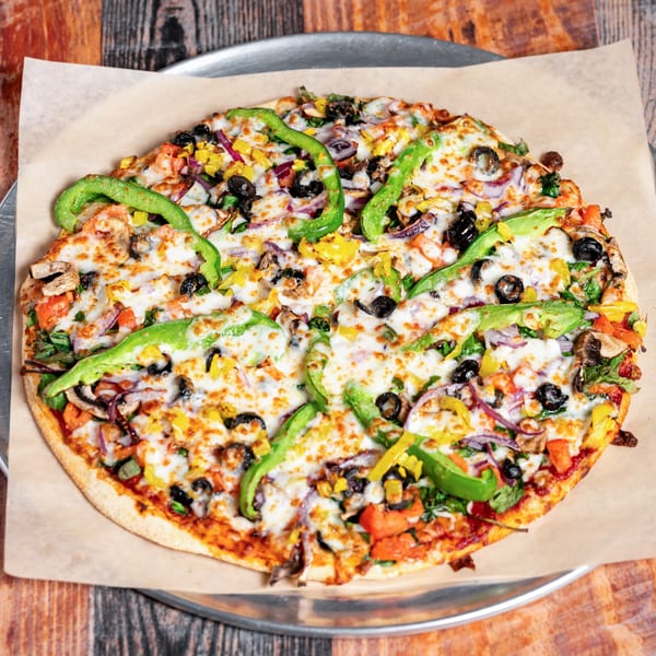 Kozi Italian Street Food's veggie pizza, topped with green peppers, olives, mushrooms, and cheese.