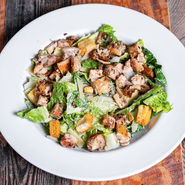 Kozi Italian Street Food's Caesar salad with grilled chicken, croutons, and parmesan cheese.